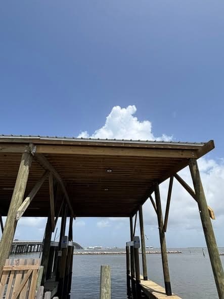 Before: a plain phone photo of a finished waterfront boathouse, posted without branding or story